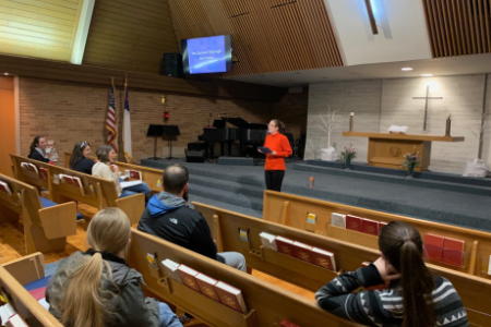 Crystal presenting to a parent group gathered in a church sanctuary